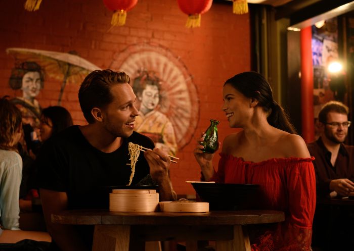 Couple enjoying food and drink at Spice Alley - Chippendale