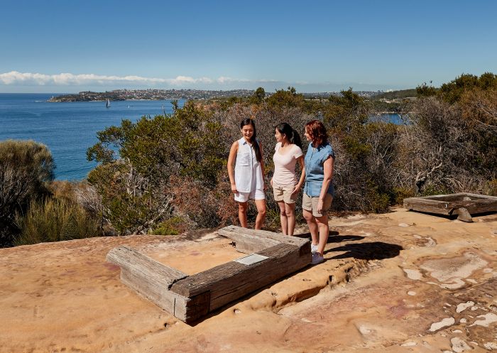 Friends visiting the Grotto Point Aboriginal engravings along the Spit Bridge to Manly Walk, Sydney