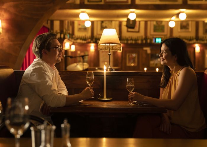 Couple enjoying food and drink at French restaurant Restaurant Hubert, Sydney City