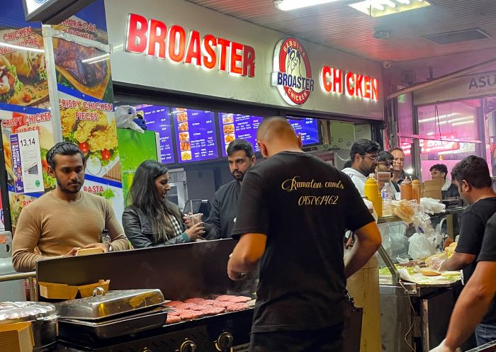 Broadster Chicken, Lakemba - Credit: Taste Tours Camel burger on the grill at Broadster Chicken, Lakemba - Credit: Taste Tours