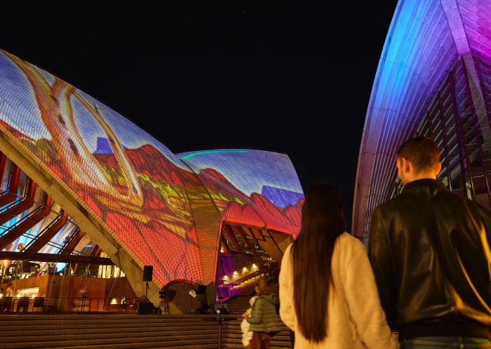 Couple enjoying the lights of Badu Gili: Winter Nights at Sydney Opera House, Circular Quay