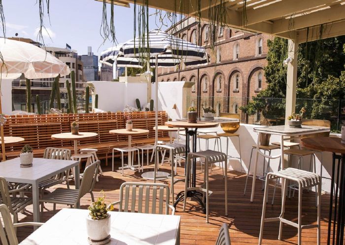 View of sunny outdoor rooftop bar at Quarryman’s Hotel Rooftop, Pyrmont