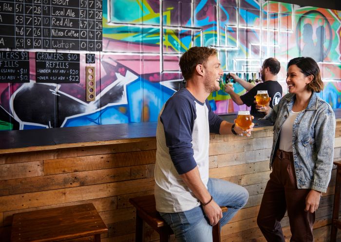 Couple enjoying a beer tasting session at Rusty Penny Brewing, Penrith