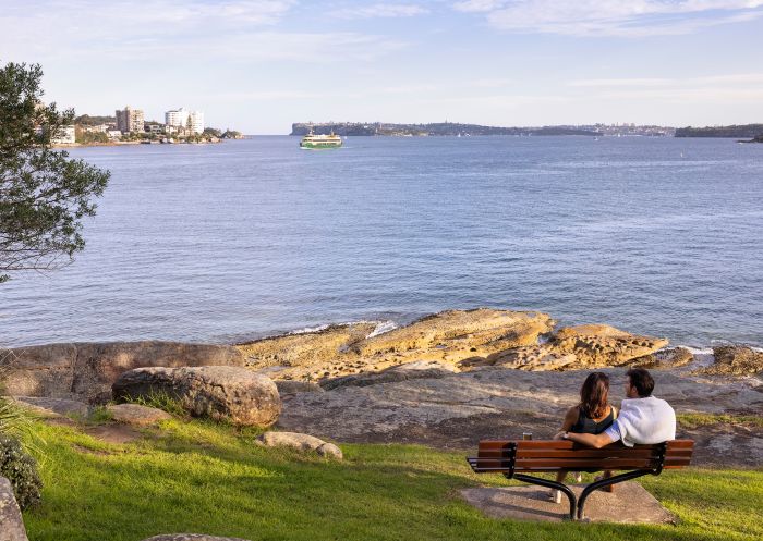 Couple enjoying scenic views across North Harbour from Fairlight Walk, Manly