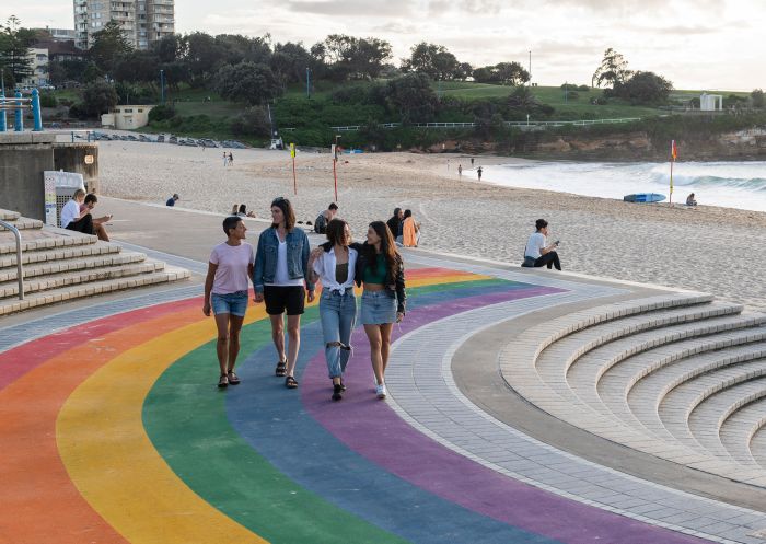 Couples walking along the rainbow staircase at Coogee Beach