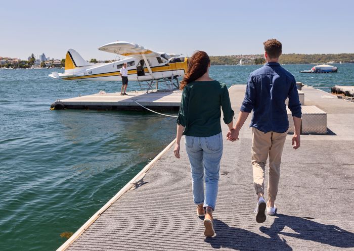 Couple walking towards seaplane at Sydney Seaplanes, Rose Bay