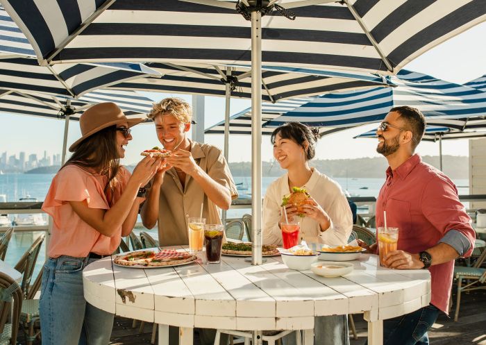 Friends enjoying food and drinks on a sunny day at Watsons Bay Hotel, Watsons Bay