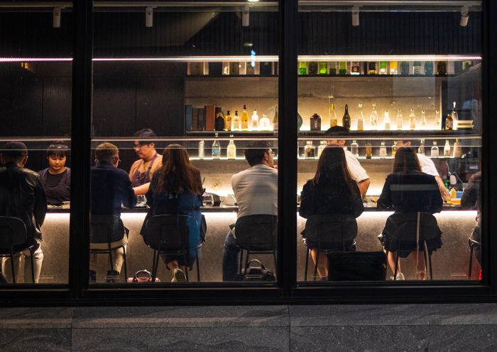 Kobo Restaurant, Sydney CBD - Credit: Tim Cavanna Exterior photo of people dining at the bar at Kobo, Sydney CBD