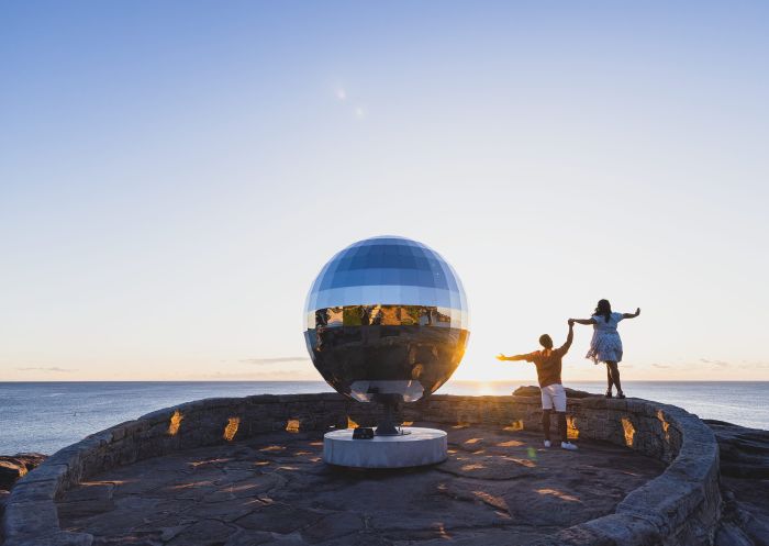 Couple enjoying Sculpture by the Sea 2022 at Mackenzies Point Lookout, Bondi