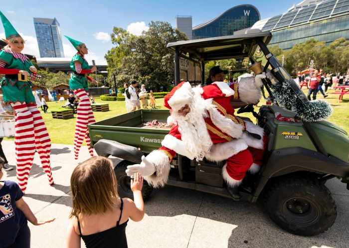 Santa visits children at Deck The Harbour, Darling Harbour
