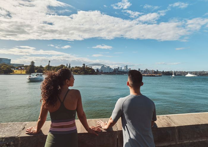 Couple enjoying the harbour view at the Royal Botanic Gardens, Sydney