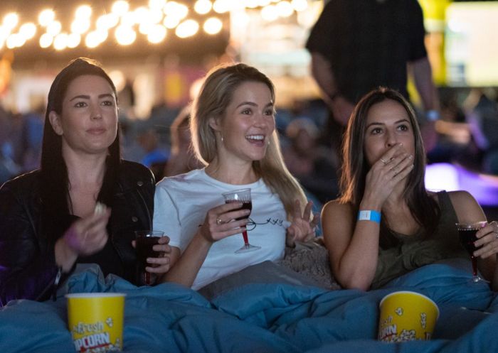 Friends at outdoor cinema at Mov'in Bed Beach Cinema, Barangaroo