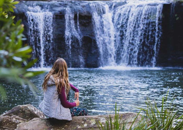 Woman enjoying waterfall at Nellies Glen, Budderoo National Park