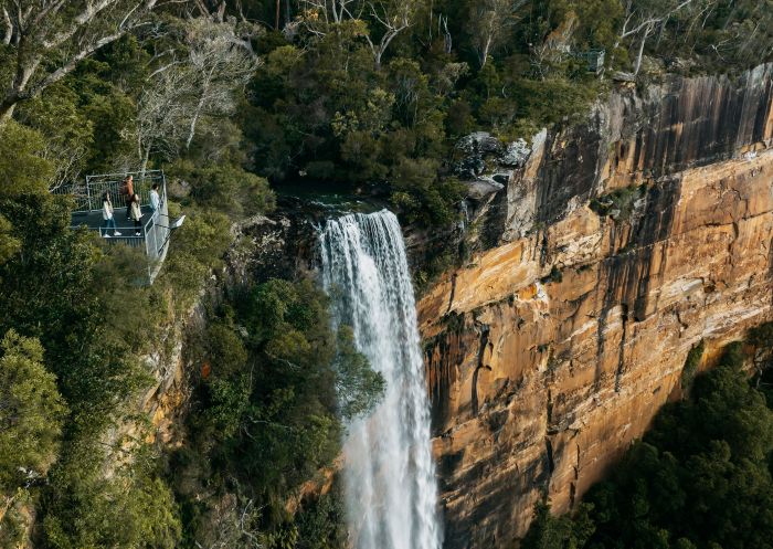 Aerial view of people standing at the viewpoint above Fitzroy Falls, Kangaroo Valley