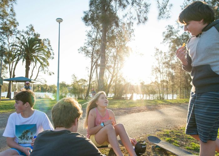 Kids playing on their skateboards at Narrabeen Lagoon, Narrabeen