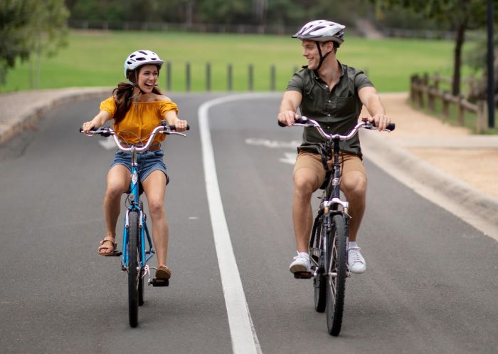 Couple enjoying a bike ride inside Parramatta Park, Parramatta