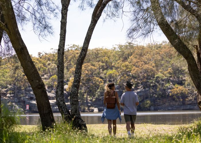 Couple enjoying the views across the scenic Georges River in Georges River Nature Reserve, Campbelltown