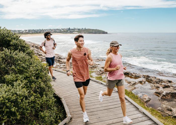 Friends enjoying coastal run, Freshwater Beach
