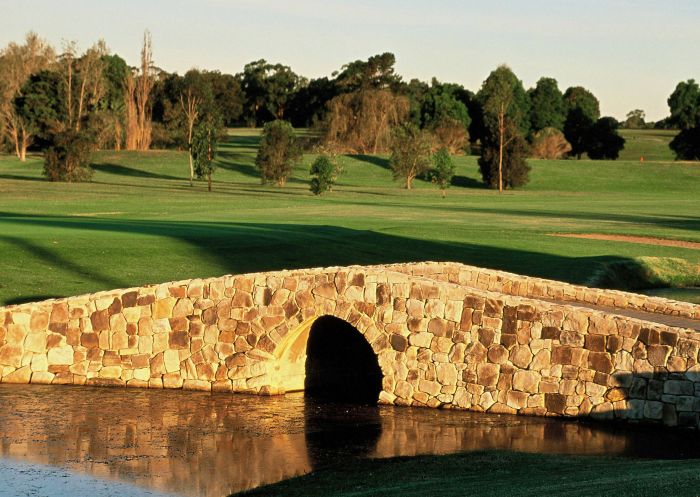 View of sandstone bridge over the lake at Camden Golf Club, Studley Park