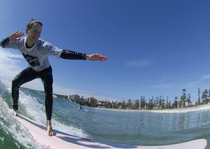Man enjoying a surf with Manly Surf School at Manly Beach, Manly 