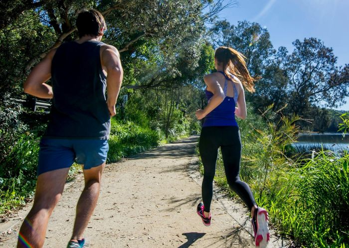 Couple running around Narrabeen Lagoon, Narrabeen