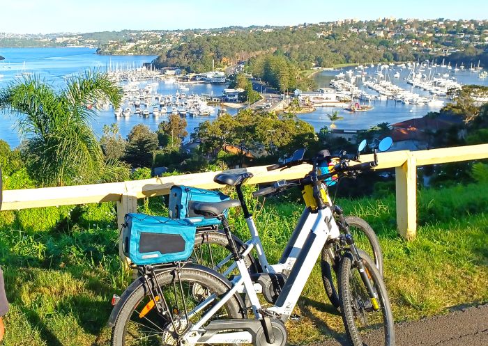 Man cycling past the The Spit and Middle Harbour with Bespoke Cycles Tours