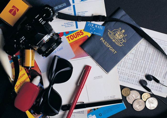 Travel items including Australian passport and coins