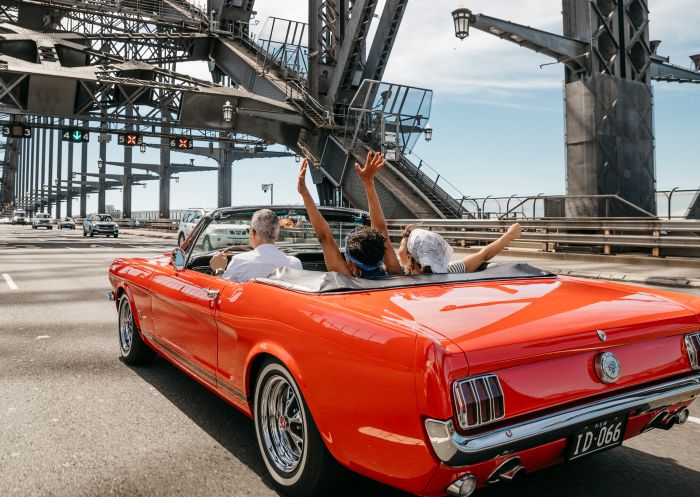 Friends enjoying a scenic drive over the Sydney Harbour Bridge, Sydney