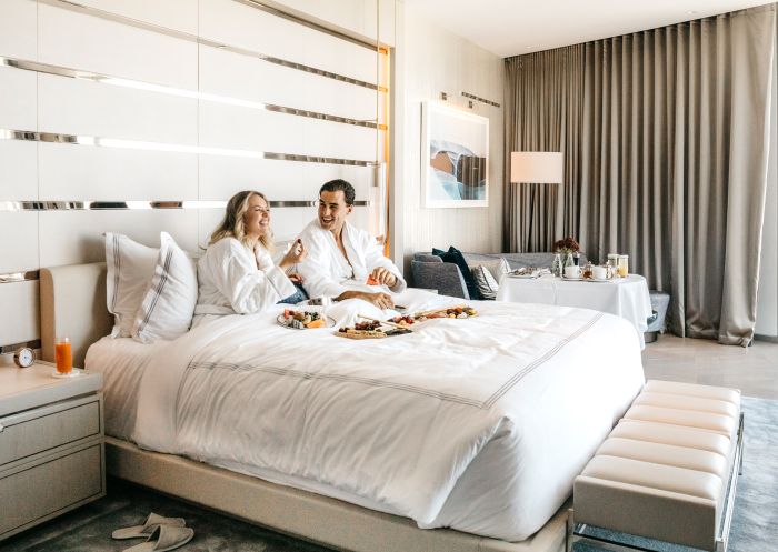 Crown Sydney, Barangaroo Couple enjoying breakfast in bed at Crown Sydney, Barangaroo
