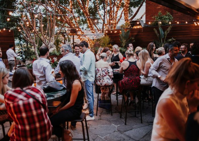 People enjoying a drink in the courtyard at The Golden Sheaf, Double Bay