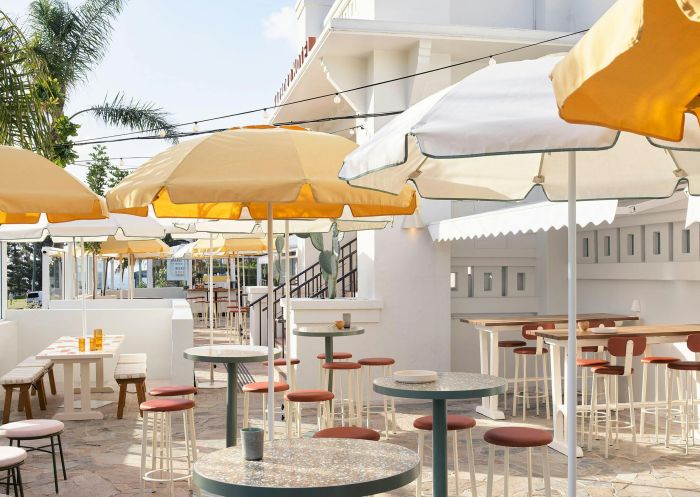 Sunny courtyard with umbrellas at Harbord Hotel, Freshwater