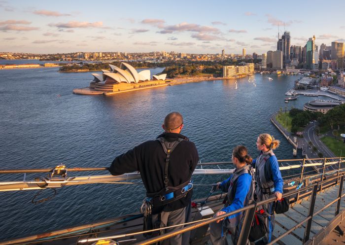 People looking over the harbour to the Sydney Opera House at sunset, BridgeClimb Sydney
