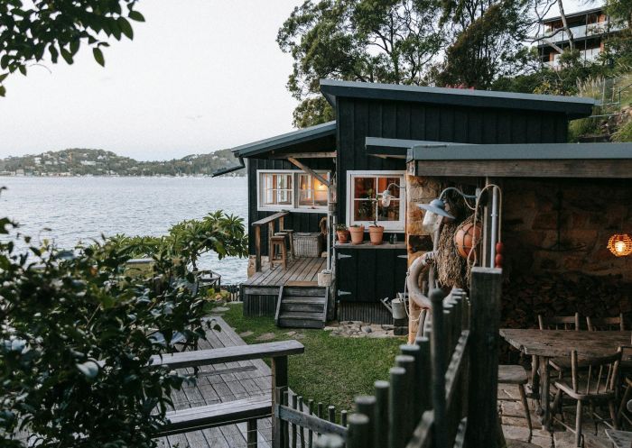 The Little Black Shack, Great Mackeral Beach - Credit: Indiana Kwong Outdoor view of the deck overlooking the water at The Little Black Shack, Great Mackeral