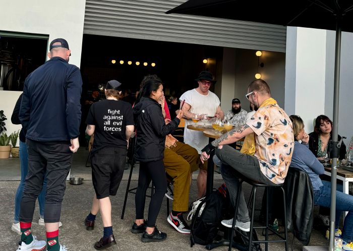 People enjoying a beer in the busy courtyard at Kicks Brewing, Marrickville