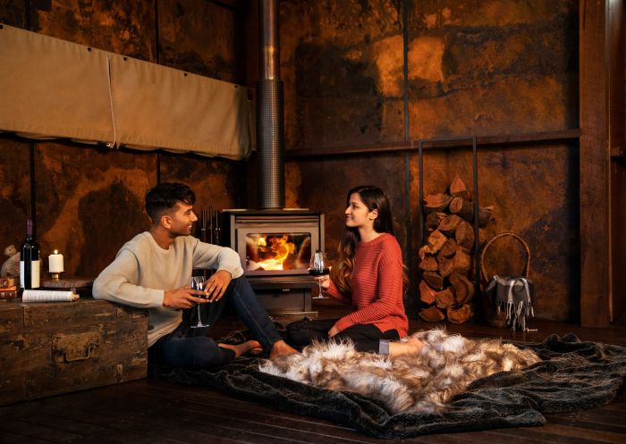 Spicers Sangoma Retreat, Bowen Mountain Couple enjoying a romantic night by the fireplace at Spicers Sangoma Retreat, Bowen Mountain.
