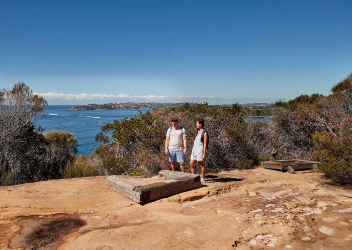 Couple visiting the Grotto Point Aboriginal engravings, Spit Bridge to Manly walk