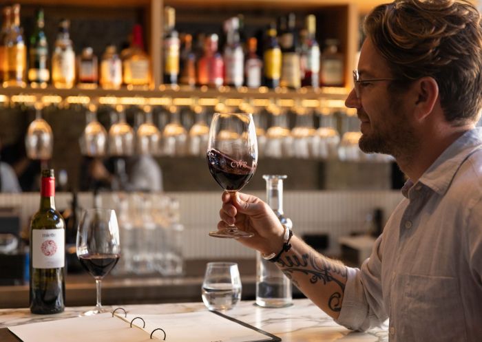 Man enjoying a glass of red wine, Coogee Wine Room, Coogee