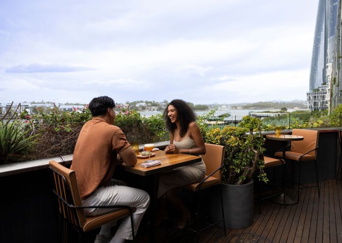Couple enjoying a drink at the rooftop bar, Smoke, Barangaroo