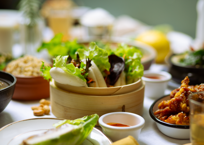 Bao buns and dishes on table, Little Turtle Vegan Restaurant, Enmore - Credit: Little Turtle Vegan Restaurant