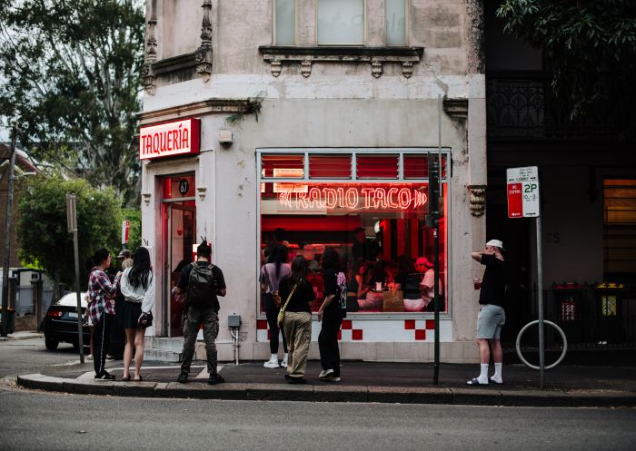 People lining up outside of venue with neon signs, Radio Taco, Chippendale - Credit: Alana Dimou