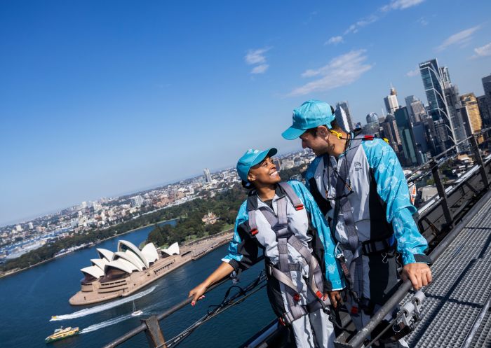 Young couple smiling at each other on top of the harbour bridge, Sydney