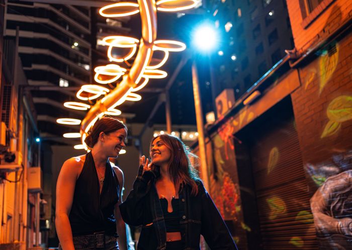 Friends experiencing the neon lit laneways, Parramatta Lanes Festival, Parramatta