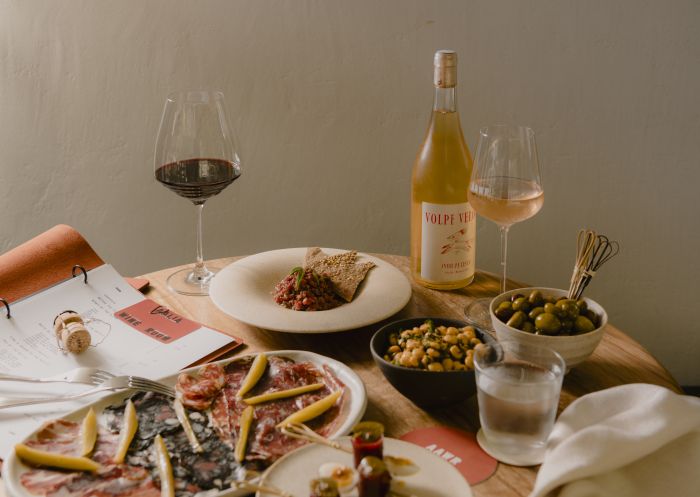 Table with wine and side dishes, Aalia Wine Room, Sydney - Credit: Jiwon Kim