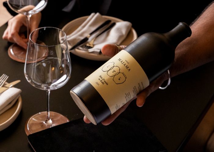 Holding bottle of wine, Bazaar & Bar, Brookvale - Credit: Bazaar & Bar