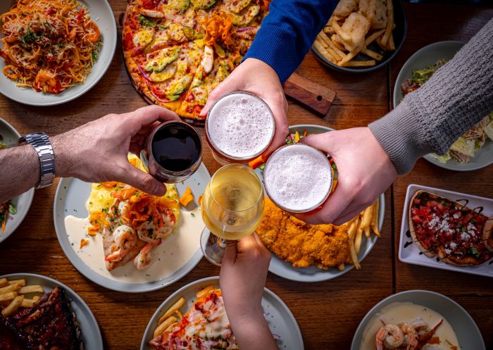 People holding drinks over food, Appin Hotel, Appin - Credit: Monarch Hotels