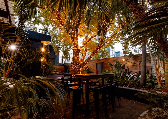 Outdoor table with fairy lights in tree , The East Village, Balmain - Credit: The East Village