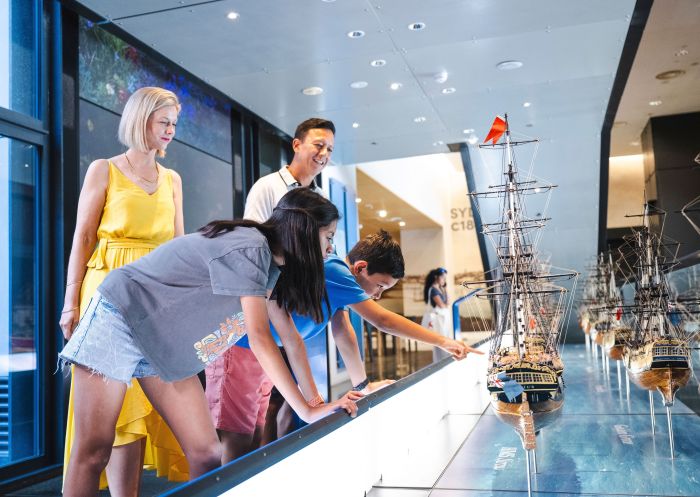 Family visiting and looking at sailing boats, Museum of Sydney, Sydney