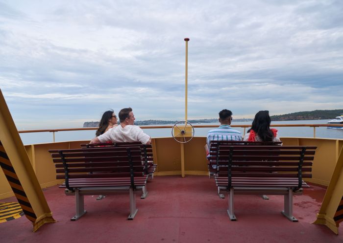 Ferry with people sitting looking at view, Circular Quay to Manly Ferry, Sydney