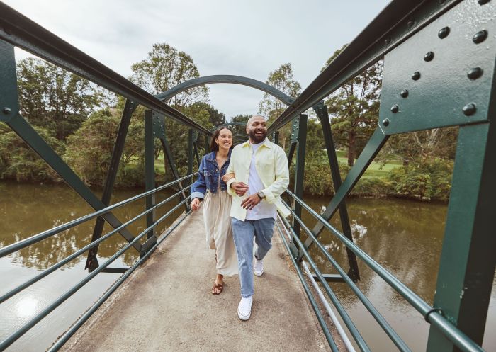 Couple walk across the bridge, Noller Bridge, Parramatta Park