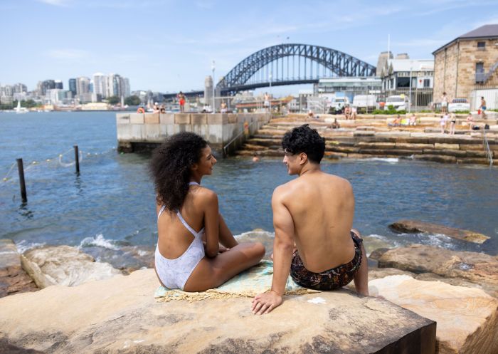 Couple enjoying a swim with harbour view, Marrinawi Cove, Barangaroo 
